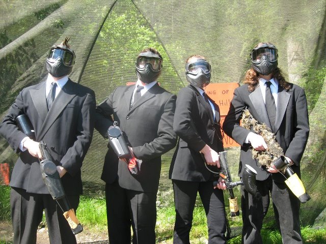 Paintball players wearing suits and ties